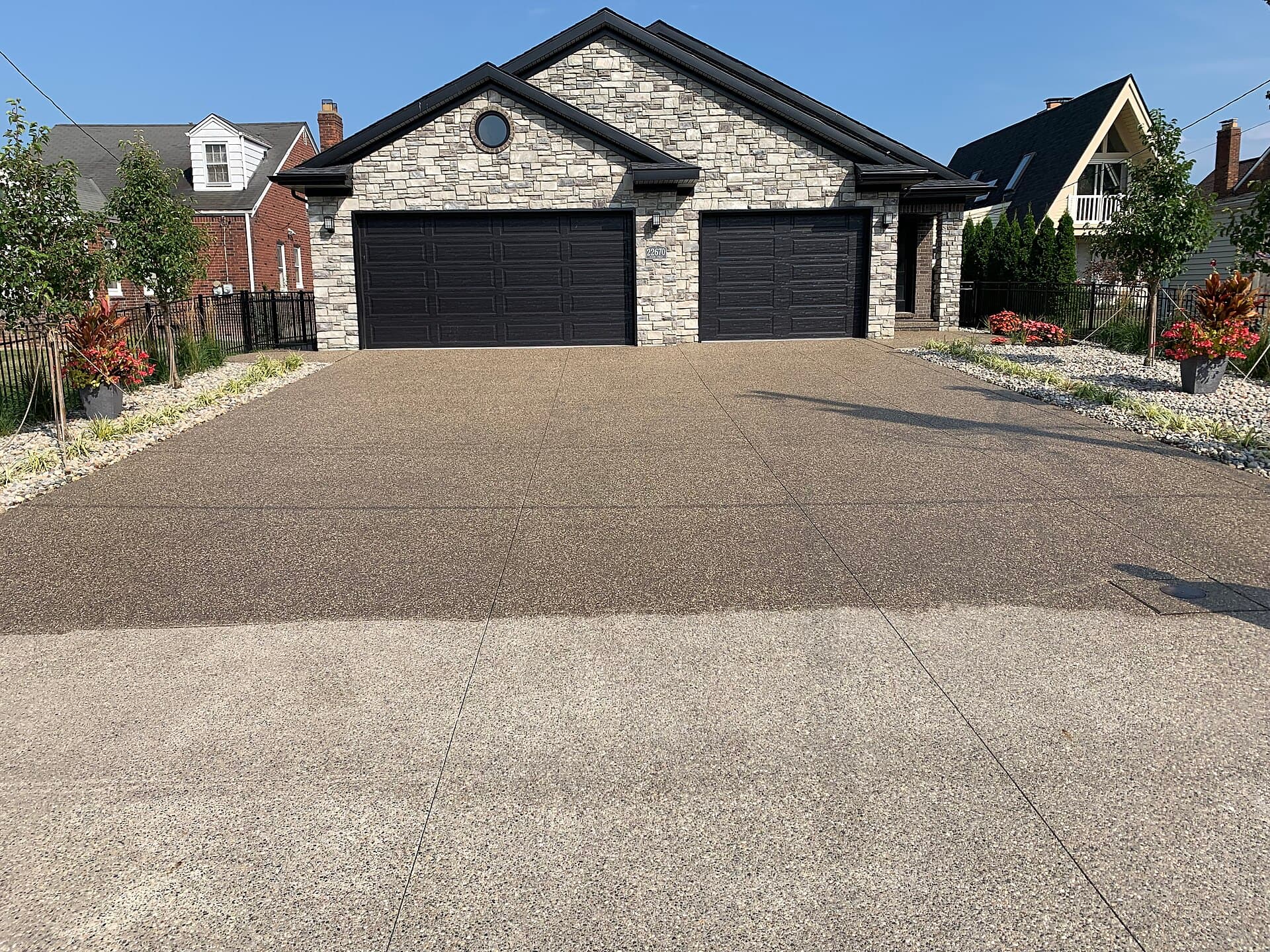Washing and sealing exposed aggregate concrete.
