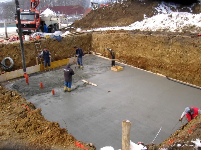 Concrete being poured into a basement.