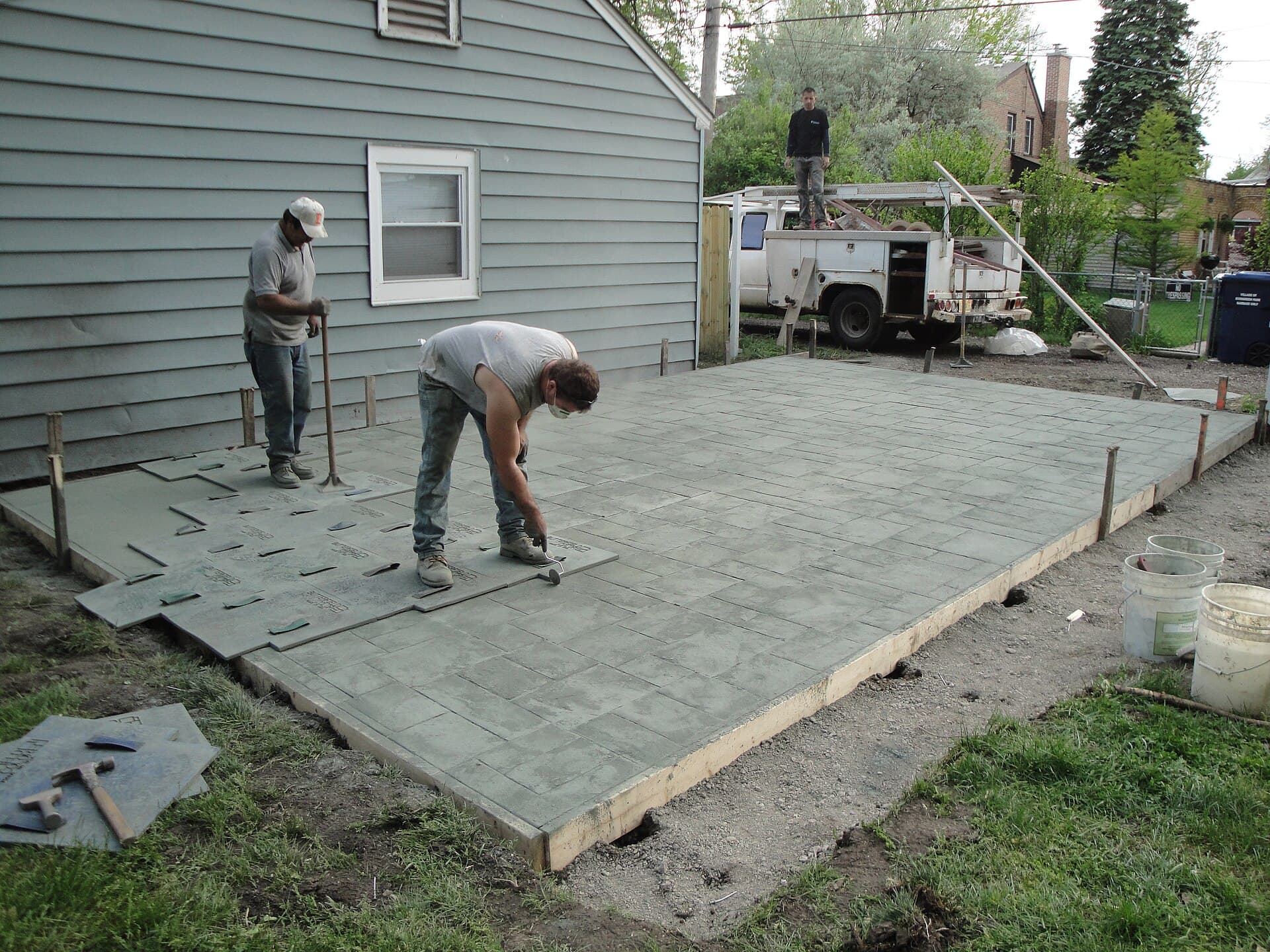 Concrete being stamped with a slate pattern